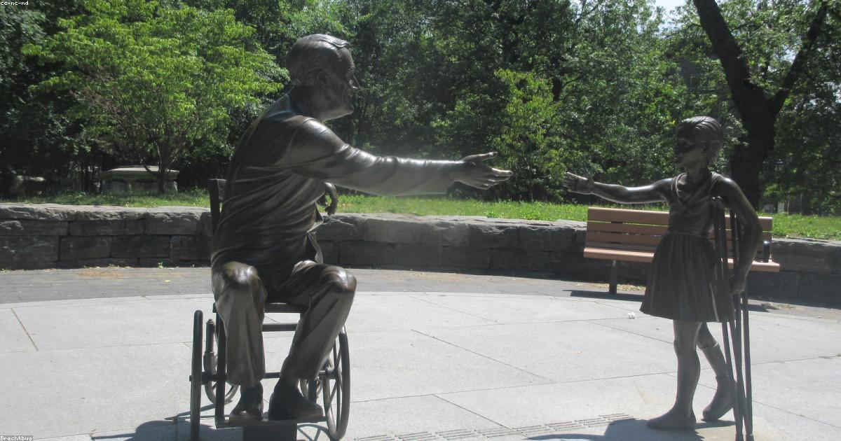A Young Girl Is Sitting On A Bench In A Wheelchair